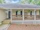 Close-up of a welcoming covered front porch with a wooden railing and decorative shutters at 250 Daileys Plantation Dr, Mcdonough, GA 30253
