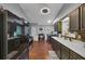 Spacious kitchen with stainless steel appliances, dark cabinets, and hardwood floors at 250 Daileys Plantation Dr, Mcdonough, GA 30253