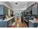 Bright kitchen with stainless steel appliances, dark cabinets, and hardwood floors at 250 Daileys Plantation Dr, Mcdonough, GA 30253