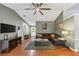 Open-concept living room featuring hardwood floors, a comfortable sectional, and modern decor at 250 Daileys Plantation Dr, Mcdonough, GA 30253