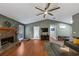 Inviting living room with hardwood floors, a brick fireplace, and ample natural light at 250 Daileys Plantation Dr, Mcdonough, GA 30253