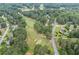 Aerial view of the golf course community with mature trees and a pond at 705 Clubhouse Se Dr, Conyers, GA 30094
