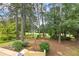 Beautiful backyard view with mature trees and swing set at 705 Clubhouse Se Dr, Conyers, GA 30094
