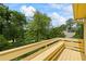 Enjoy a scenic view of mature trees and greenery from the home's balcony at 705 Clubhouse Se Dr, Conyers, GA 30094