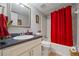 Bathroom featuring a sink vanity with white cabinets and a bathtub with a red curtain at 705 Clubhouse Se Dr, Conyers, GA 30094