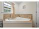 A luxurious soaking tub with a tile surround offers a relaxing retreat at 705 Clubhouse Se Dr, Conyers, GA 30094