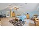 Spacious bedroom with angled ceilings featuring soft blue paint, a ceiling fan, and carpeted floors at 705 Clubhouse Se Dr, Conyers, GA 30094