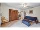 Bedroom with closet doors, adjacent to a chair, futon, and storage chest at 705 Clubhouse Se Dr, Conyers, GA 30094