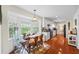 Charming dining area with hardwood floors, bright windows, a wooden table, and white cabinets at 705 Clubhouse Se Dr, Conyers, GA 30094