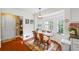Cozy dining area featuring hardwood floors, a wooden table, comfortable seating, and large windows at 705 Clubhouse Se Dr, Conyers, GA 30094