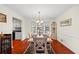 Dining room features a chandelier, chair rail detail, hardwood floors, and views into the kitchen at 705 Clubhouse Se Dr, Conyers, GA 30094