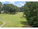 Lush golf course view with mature trees and winding cart paths offering scenic recreation at 705 Clubhouse Se Dr, Conyers, GA 30094