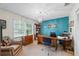 Home office with blue accent wall, light carpet and a large window at 705 Clubhouse Se Dr, Conyers, GA 30094