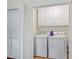 Convenient laundry room with a full-size washer and dryer and extra storage at 705 Clubhouse Se Dr, Conyers, GA 30094
