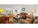 Living room and dining area with beautiful wood floors, furniture, and natural light at 705 Clubhouse Se Dr, Conyers, GA 30094