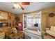 Cozy living room featuring a brick fireplace, ceiling fan, and open doorway to the connected room at 705 Clubhouse Se Dr, Conyers, GA 30094