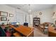 Bright office with wood desk, comfortable seating, and elegant chandelier at 705 Clubhouse Se Dr, Conyers, GA 30094