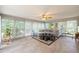 Bright sunroom features neutral sectional, ample windows, tiled floors, and decorative accents at 705 Clubhouse Se Dr, Conyers, GA 30094