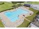 Aerial view of a sparkling pool with lounge chairs and tables for relaxing at 705 Clubhouse Se Dr, Conyers, GA 30094