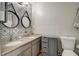 Double vanity bathroom features granite countertops, round mirrors, and decorative wallpaper at 1753 Liberty Pkwy, Atlanta, GA 30318