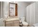 Bathroom with a granite countertop vanity, toilet, and a shower with patterned curtains at 1753 Liberty Pkwy, Atlanta, GA 30318