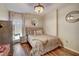 Cozy bedroom with wood flooring, a comfortable bed, and stylish décor at 1753 Liberty Pkwy, Atlanta, GA 30318