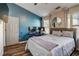 Stylish bedroom with blue accent wall, desk and bed, with streaming sunlight at 1753 Liberty Pkwy, Atlanta, GA 30318