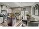 Eat-in kitchen featuring an island, white subway tile backsplash, stainless appliances, and modern dining area at 1753 Liberty Pkwy, Atlanta, GA 30318