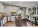 The open-concept kitchen boasts stainless appliances, an island, and a dining area with mirrors at 1753 Liberty Pkwy, Atlanta, GA 30318