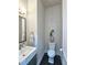 Modern half bathroom features tile accent wall, dark floors and sink at 4107 Township Pkwy # 69, Sandy Springs, GA 30342