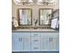 Spacious bathroom featuring a double vanity with two mirrors, decorative tiling, and modern fixtures at 4107 Township Pkwy # 69, Sandy Springs, GA 30342