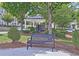 A community bench in a landscaped area, shaded by mature trees and offering a relaxing spot for residents at 4107 Township Pkwy # 69, Sandy Springs, GA 30342