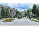 Gated community entrance with lush landscaping and decorative flowerbeds at 4107 Township Pkwy # 69, Sandy Springs, GA 30342