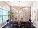 Dining room featuring a brick accent wall, modern chandelier, and ample natural light at 4107 Township Pkwy # 69, Sandy Springs, GA 30342