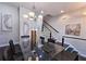 Dining area with modern chandelier, artwork, and a staircase in the background at 4107 Township Pkwy # 69, Sandy Springs, GA 30342