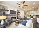 Cozy living room with a brick fireplace, TV, and open floor plan to the modern kitchen at 4107 Township Pkwy # 69, Sandy Springs, GA 30342