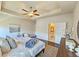 Bright main bedroom featuring tray ceilings, stylish decorations, dark wood floors, and an ensuite bathroom at 4107 Township Pkwy # 69, Sandy Springs, GA 30342
