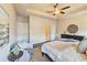 Comfortable main bedroom featuring an area rug, tray ceiling, dark wood flooring, and ceiling fan at 4107 Township Pkwy # 69, Sandy Springs, GA 30342