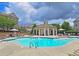 Community pool with lounge chairs and a charming pool house at 4107 Township Pkwy # 69, Sandy Springs, GA 30342
