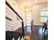 Staircase area with hardwood floors, modern railing and lighting at 4107 Township Pkwy # 69, Sandy Springs, GA 30342