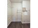 Walk-in closet with custom wire shelving and dark wood flooring at 4107 Township Pkwy # 69, Sandy Springs, GA 30342