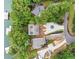 Aerial view of a lakefront property with a circular driveway, green space, mature trees, and lake access at 6900 Driskell Cir, Cumming, GA 30041