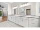 Bright bathroom features double vanity with gray countertops, modern lighting and frameless glass shower at 6900 Driskell Cir, Cumming, GA 30041