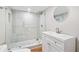 Modern bathroom featuring a walk-in shower with glass door and sleek vanity with a round mirror at 6900 Driskell Cir, Cumming, GA 30041