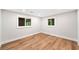 Bright bedroom with natural light, hardwood floors, recessed lighting, and fresh, neutral walls at 6900 Driskell Cir, Cumming, GA 30041