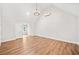 Upstairs room features high ceilings, wood floors, chandelier and modern air conditioning unit at 6900 Driskell Cir, Cumming, GA 30041