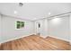 Bedroom with hardwood floors, recessed lighting, and natural light from the window at 6900 Driskell Cir, Cumming, GA 30041