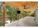 Spacious wooden deck featuring a wood plank ceiling, ceiling fan, mounted TV, and scenic views at 6900 Driskell Cir, Cumming, GA 30041
