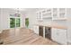 Dining area with built-in cabinets and wine storage, and sliding glass doors to the deck at 6900 Driskell Cir, Cumming, GA 30041