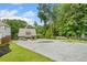 Spacious driveway leading up to a charming home, complete with landscaping and mature trees at 6900 Driskell Cir, Cumming, GA 30041
